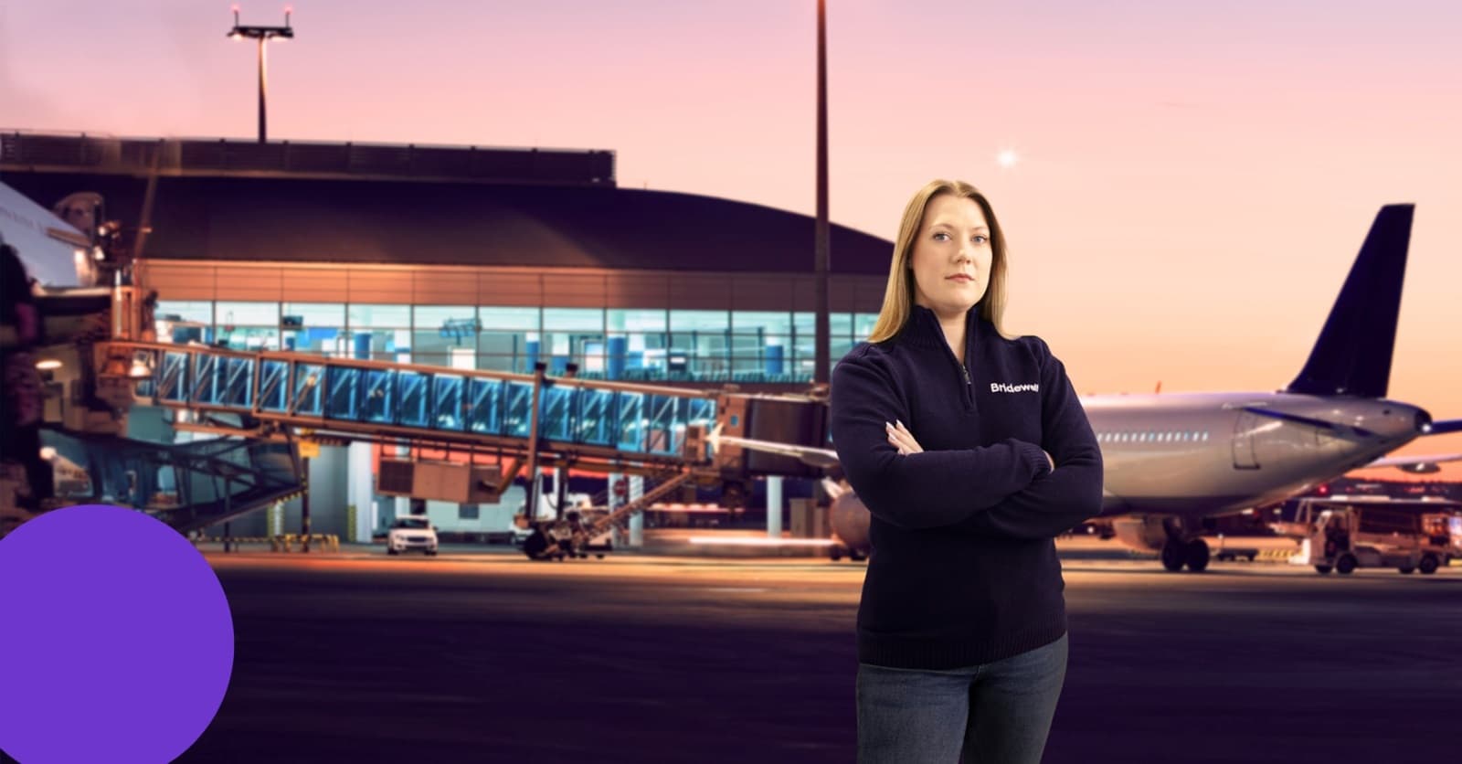 Airport hangar at sunset with aircraft